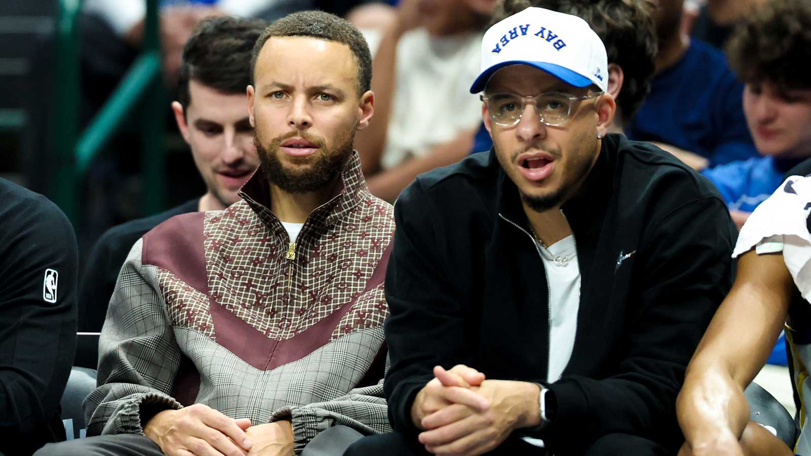 Golden State Warriors guard Stephen Curry (left) sits with Golden State Warriors guard Seth Curry (right) during the first half against the Dallas Mavericks at American Airlines Center. 