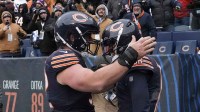 Chicago Bears quarterback Caleb Williams (18) celebrates with center Drew Dalman (52) after scoring the game-winning touchdown against New York Giants during the fourth quarter at Soldier Field.