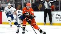 Anaheim Ducks center Leo Carlsson (91) and Toronto Maple Leafs left wing Matthew Knies (23) battle for the puck during the second period at Honda Center.