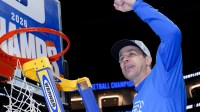 Duke Blue Devils head coach Jon Scheyer cuts down the net after defeating the Virginia Cavaliers in the men's ACC Conference Tournament Championship at Spectrum Center.