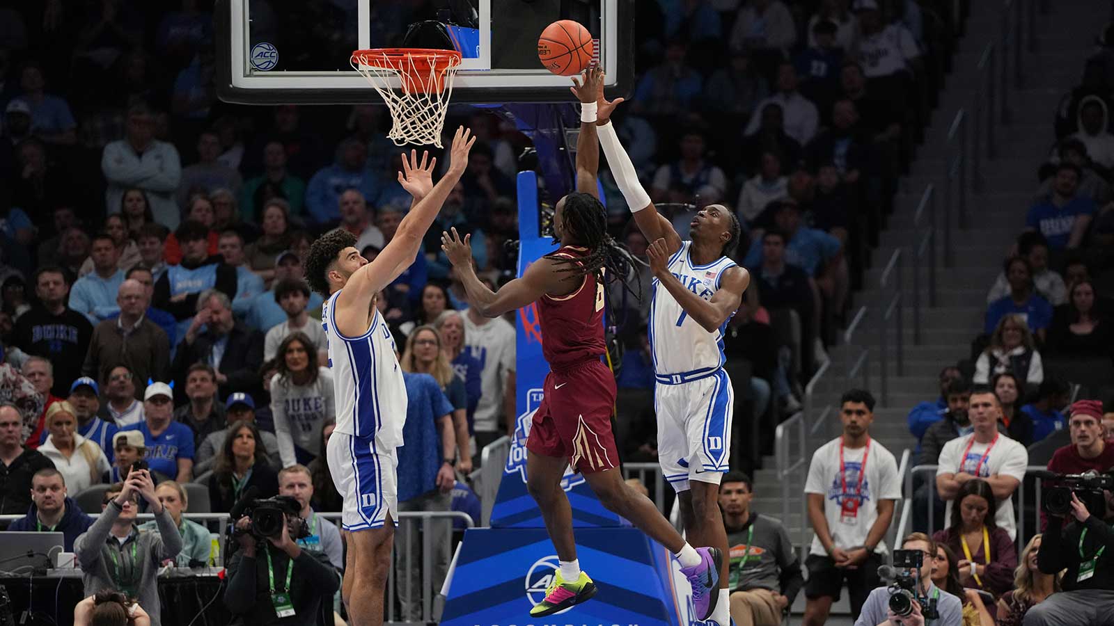 Florida State Seminoles guard Robert McCray V. (6) shoots as Duke Blue Devils forward Cameron Boozer (12) and guard Dame Sarr (7) defend in the second half at Spectrum Center.