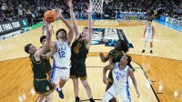Duke Blue Devils forward Cameron Boozer (12) shoots the ball over Siena Saints center Riley Mulvey (55) in the second half during a first round game of the men's 2026 NCAA Tournament at Bon Secours Wellness Arena.