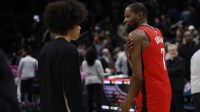 Houston Rockets forward Kevin Durant (7) instructs Washington Wizards forward Kyshawn George (L) on the court after their game at Capital One Arena.