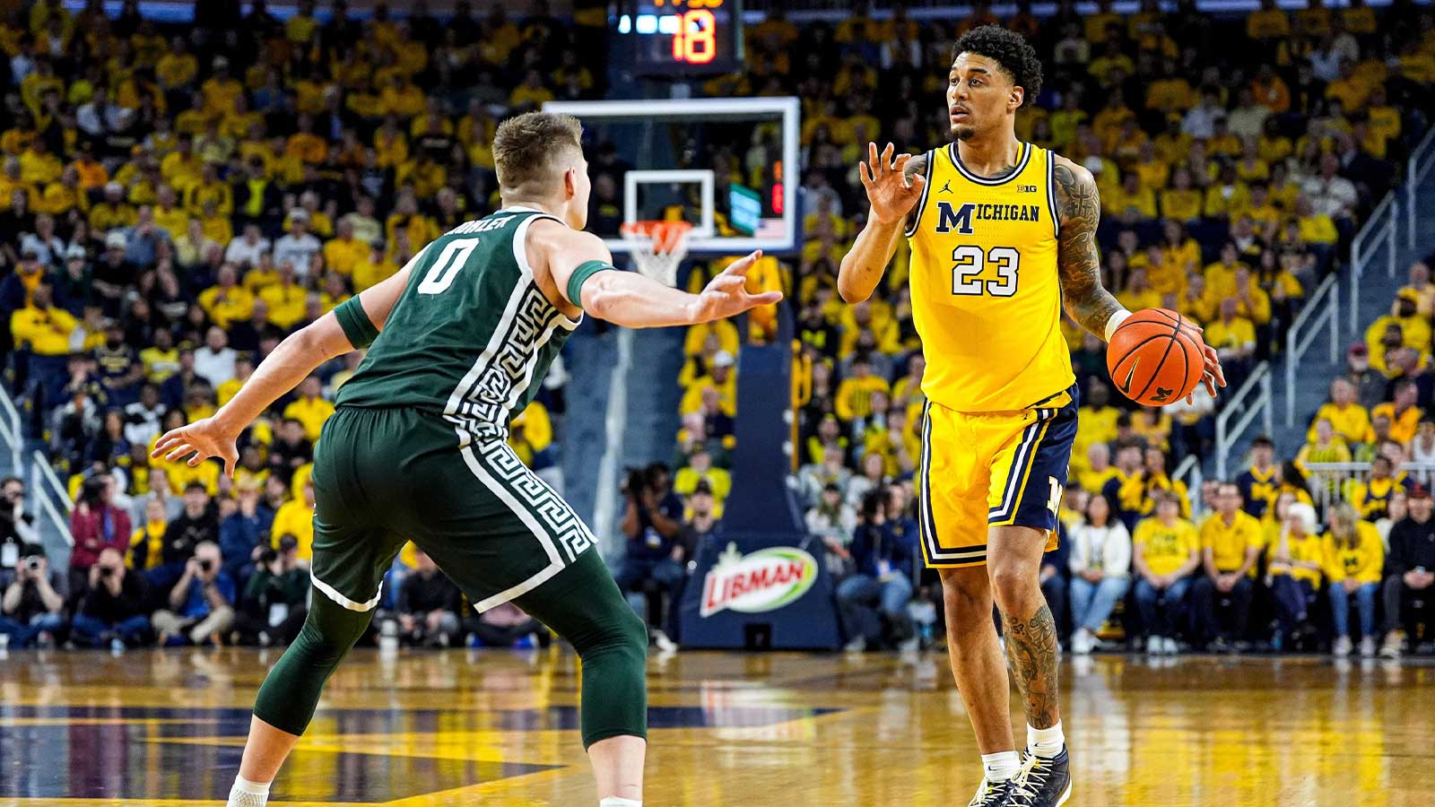 Michigan forward Yaxel Lendeborg (23) looks to pass the ball against Michigan State forward Jaxon Kohler (0) during the first half at Crisler Center in Ann Arbor on Sunday, March 8, 2026.