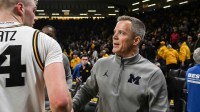 Michigan Wolverines head coach Dusty May talks with with Iowa Hawkeyes guard Bennett Stirtz (14) after the game at Carver-Hawkeye Arena.