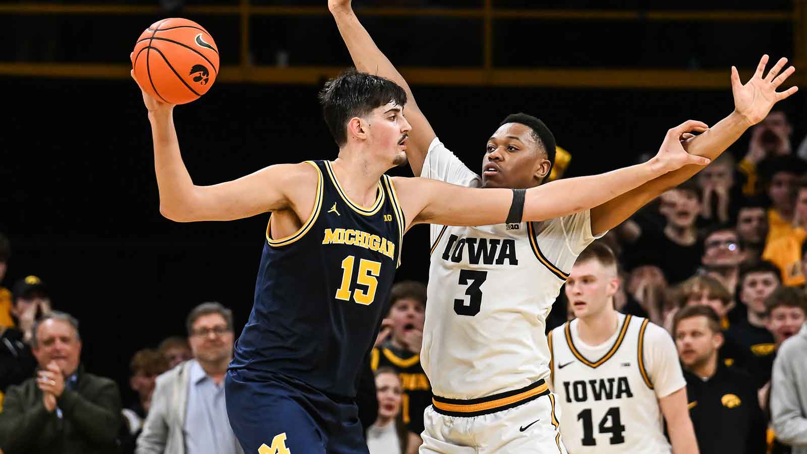Michigan Wolverines center Aday Mara (15) controls the ball as Iowa Hawkeyes forward Cam Manyawu (3) defends during the second half at Carver-Hawkeye Arena.