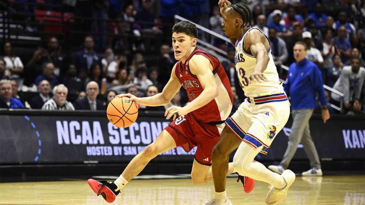St. John's Red Storm guard Dylan Darling (0) controls the ball against Kansas Jayhawks guard Elmarko Jackson (13) in the second half during a second round game of the men's 2026 NCAA Tournament at Viejas Arena.