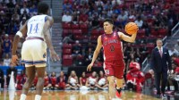St. John's Red Storm guard Dylan Darling (0) controls the ball against the Kansas Jayhawks in the first half during a second round game of the men's 2026 NCAA Tournament at Viejas Arena.