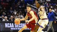 St. John's Red Storm guard Dylan Darling (0) controls the ball against Kansas Jayhawks guard Elmarko Jackson (13) in the second half during a second round game of the men's 2026 NCAA Tournament at Viejas Arena.