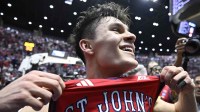 St. John's Red Storm guard Dylan Darling (0) celebrates after defeating the Kansas Jayhawks in the second half during a second round game of the men's 2026 NCAA Tournament at Viejas Arena.