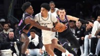 San Antonio Spurs guard Dylan Harper (2) tries to split the defense of Miami Heat guard Davion Mitchell (45) and guard Tyler Herro (14) during the first half at Kaseya Center.