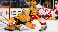 Nashville Predators goaltender Juuse Saros (74) blocks the shot of Detroit Red Wings center Dylan Larkin (71) during the first period at Bridgestone Arena.