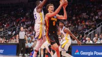 Atlanta Hawks guard Dyson Daniels (5) shoots past Golden State Warriors forward Draymond Green (23) in the first quarter at State Farm Arena.
