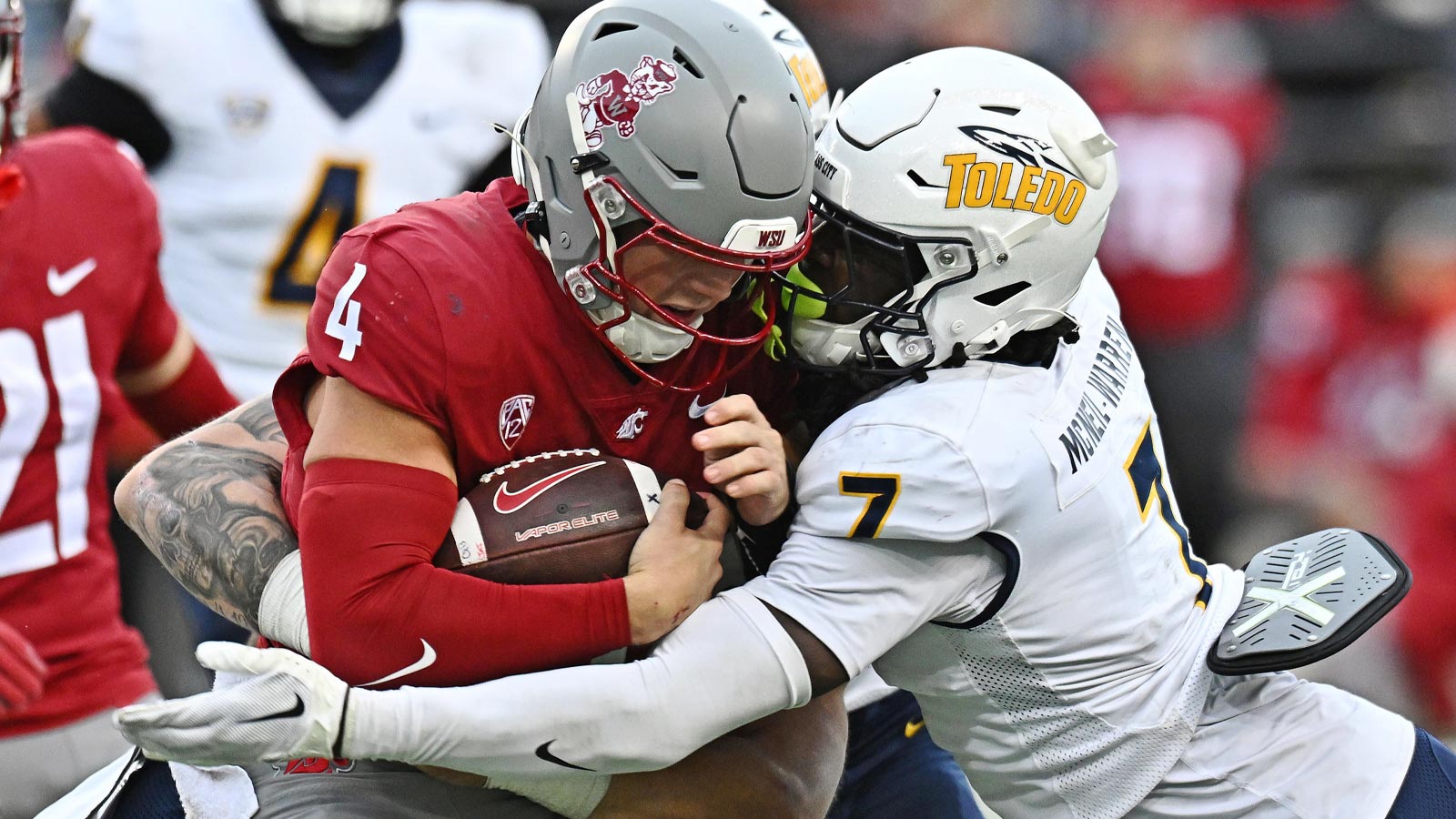 Washington State Cougars quarterback Zevi Eckhaus (4) is tackled by Toledo Rockets safety Emmanuel McNeil-Warren (7) in the second half at Gesa Field at Martin Stadium. 