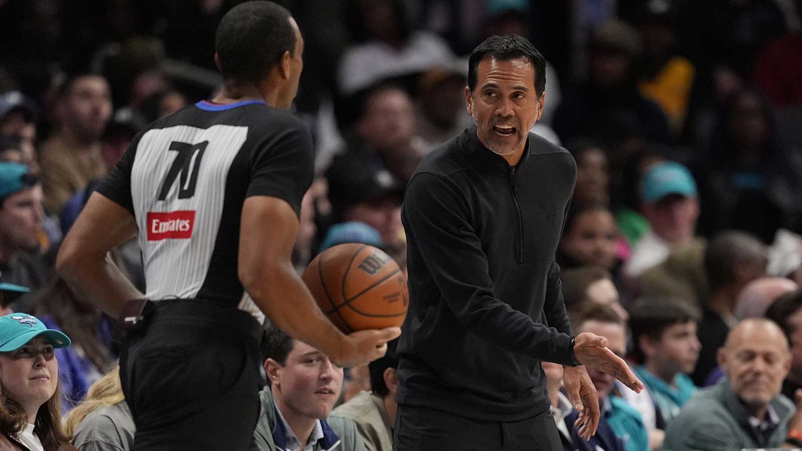 Miami Heat head coach Erik Spoelstra reacts to a call with referee Phenizee Ransom (70) during the second half against the Charlotte Hornets at Spectrum Center.