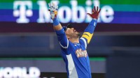 Venezuela third baseman Eugenio Suarez (7) reacts after hitting a RBI double against the United States in the ninth inning during the 2026 World Baseball Classic Championship game at loanDepot Park.
