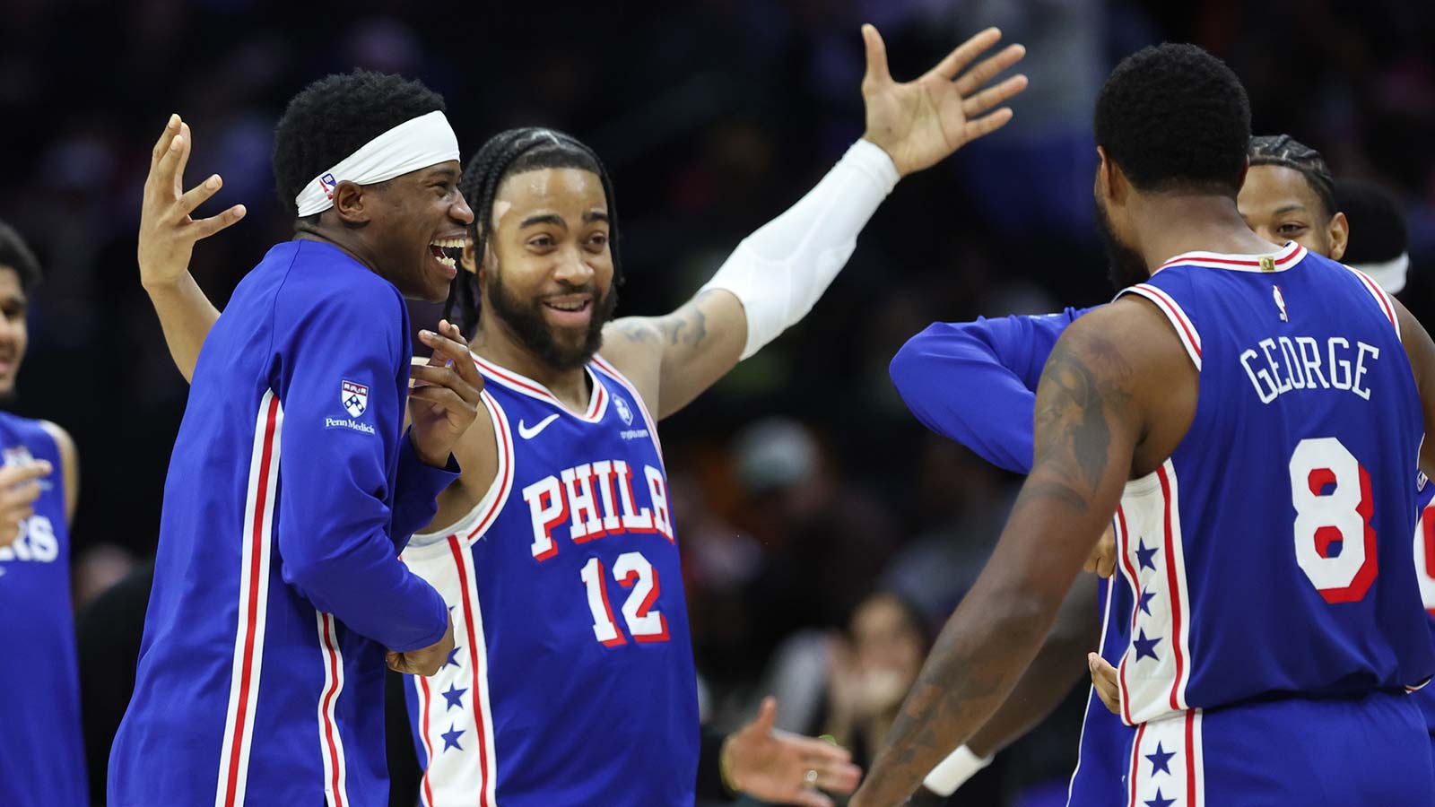 Philadelphia 76ers guard Vj Edgecombe and forward Trendon Watford (12) react with Paul George after his three pointer against the Chicago Bulls during the fourth quarter at Xfinity Mobile Arena.