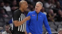 Southern Methodist University Mustangs head coach Andy Enfield talks with an official during the first half against the Louisville Cardinals at Spectrum Center.