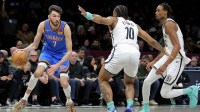 Oklahoma City Thunder center Chet Holmgren (7) controls the ball against Brooklyn Nets guard Tyson Etienne (10) and center Nic Claxton (33) during the second quarter at Barclays Center.