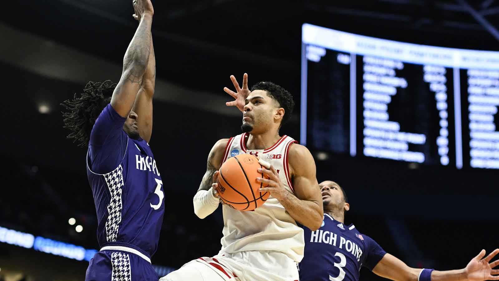 Wisconsin Badgers guard Nick Boyd (2) drives to the basket against High Point Panthers guard Rob Martin (3) during the second half of a first round game of the men's 2026 NCAA Tournament at Moda Center.