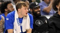 Dallas Mavericks forward Cooper Flagg (left) and guard Kyrie Irving (right) watch the game against the Oklahoma City Thunder during the second half at Dickie's Arena.