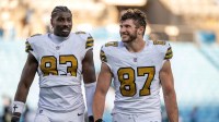 New Orleans Saints tight ends Juwan Johnson (83) and Foster Moreau (87) walk off the field after the game at Bank of America Stadium