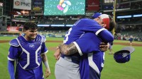 Italy pitcher Claudio Scotti (98) and manager Francisco Cervelli (29) celebrate after defeating Mexico at Daikin Park.