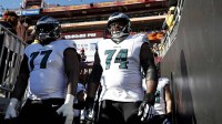 Philadelphia Eagles offensive tackle Mekhi Becton (77) and offensive tackle Fred Johnson (74) wait to take the field before the game against the Washington Commanders at Northwest Stadium.