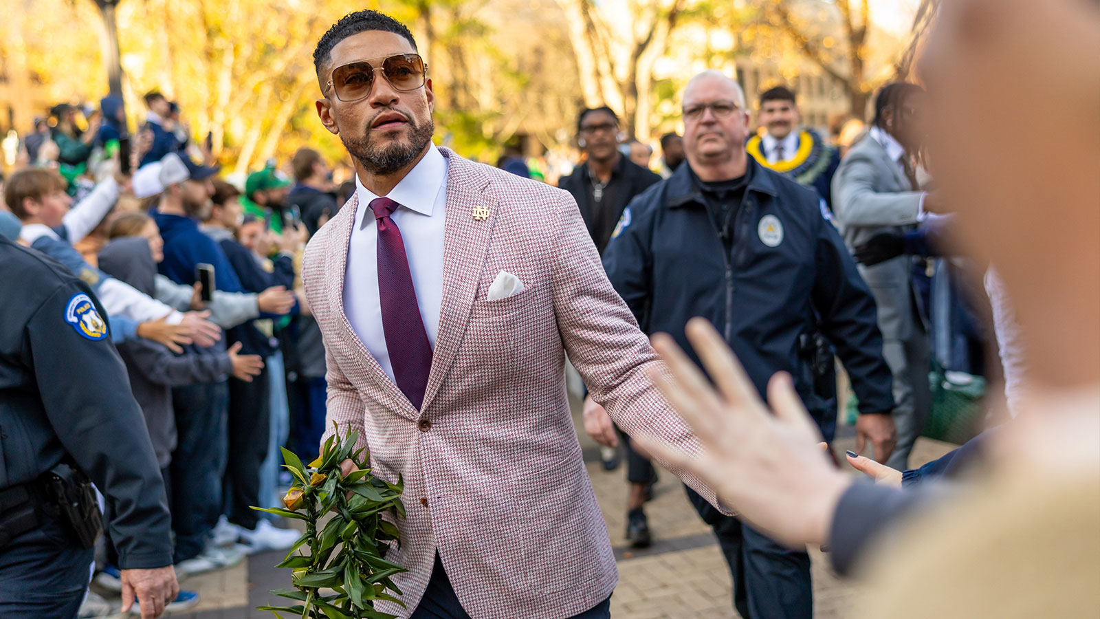 Notre Dame Fighting Irish head coach Marcus Freeman greets fans while walking to the stadium before facing the Syracuse Orange at Notre Dame Stadium.