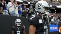 Las Vegas Raiders quarterback Geno Smith (7) and running back Ashton Jeanty (2) enter the field against the New York Giants at Allegiant Stadium.