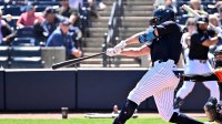 New York Yankees designated hitter Giancarlo Stanton (27) drives in a run with a sacrifice fly ball in the first inning against the Baltimore Orioles during spring training at George M. Steinbrenner Field.