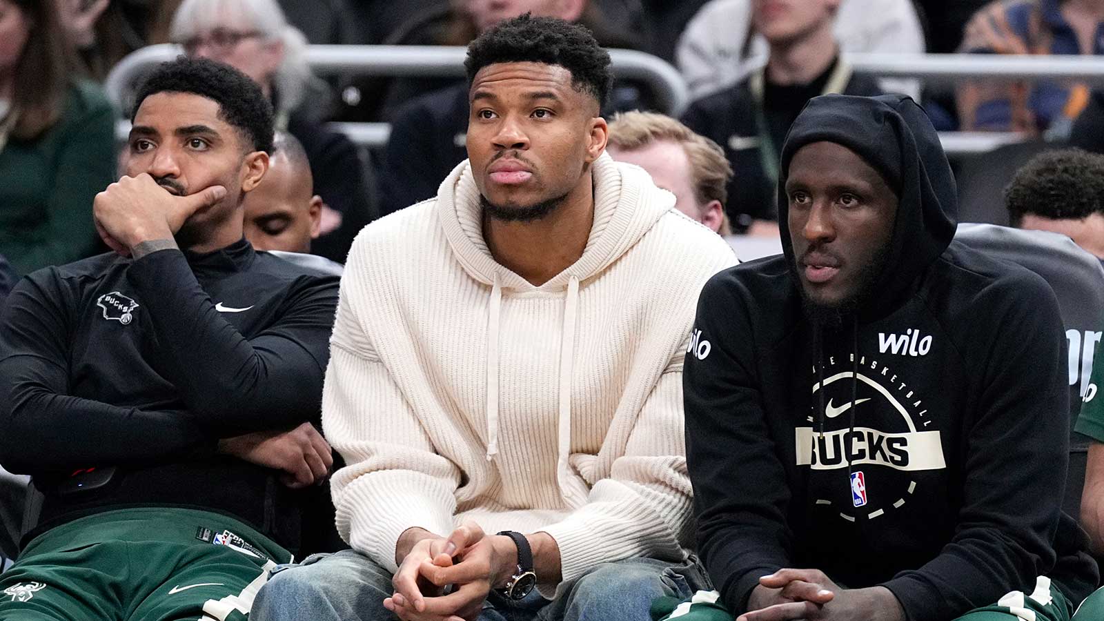 Milwaukee Bucks guard Gary Harris (11), left, Milwaukee Bucks forward Giannis Antetokounmpo (34) and Milwaukee Bucks forward Taurean Prince (12) watch the game against the Cleveland Cavaliers from the bench in the second half at Fiserv Forum.