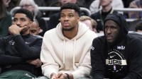 Milwaukee Bucks guard Gary Harris (11), left, Milwaukee Bucks forward Giannis Antetokounmpo (34) and Milwaukee Bucks forward Taurean Prince (12) watch the game against the Cleveland Cavaliers from the bench in the second half at Fiserv Forum.