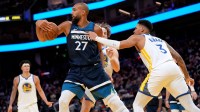 Minnesota Timberwolves center Rudy Gobert (27) holds onto a rebound next to Golden State Warriors guard Will Richard (3) in the fourth quarter at the Chase Center.