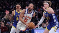 New York Knicks guard Jalen Brunson (11) drives to the basket against Golden State Warriors guards Will Richard (3) and Brandin Podziemski (2) during the third quarter at Madison Square Garden.
