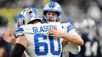Detroit Lions quarterback Jared Goff (16) greets center Graham Glasgow (60) during warm ups before a game against the Dallas Cowboys at Ford Field.