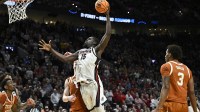 Gonzaga Bulldogs forward Graham Ike (15) dunks against Texas Longhorns center Matas Vokietaitis (8) in the second half during a second round game of the men's 2026 NCAA Tournament at Moda Center.