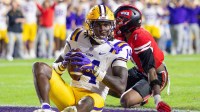 LSU Tigers tight end Trey'Dez Green (14) is tackled in the end zone for a touchdown by Western Kentucky Hilltoppers defensive back Jaylen Lewis (7) during the first half at Tiger Stadium.
