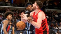 Memphis Grizzlies forward Olivier-Maxence Prosper (18) knocks the ball loose from Portland Trail Blazers center Donovan Clingan (23) during the first quarter at FedExForum. Mandatory Credit: Petre Thomas-Imagn Images