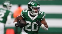 New York Jets running back Breece Hall (20) rushes the ball against the Atlanta Falcons during the first half at MetLife Stadium.