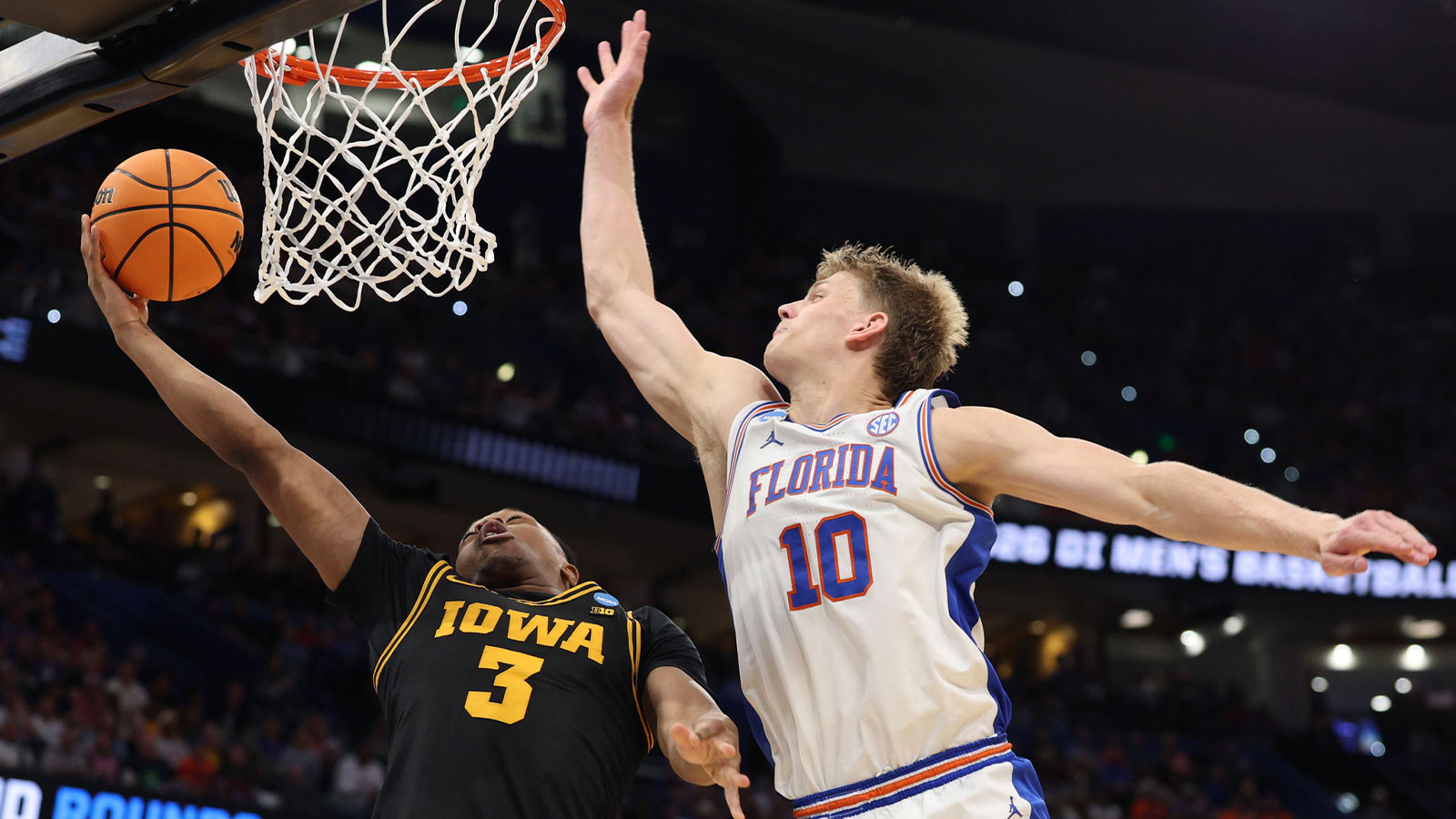 Iowa Hawkeyes forward Cam Manyawu (3) shoots past Florida Gators forward Thomas Haugh (10) in the second half during a second round game of the men's 2026 NCAA Tournament at Benchmark International Arena.