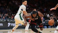 Heat center Bam Adebayo (13) drives to the basket