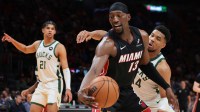Heat center Bam Adebayo (13) protects the basketball