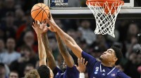 High Point Panthers forward Owen Aquino (8) blocks the shot of Wisconsin Badgers guard Nick Boyd (2) during the second half of a first round game of the men's 2026 NCAA Tournament at Moda Center.