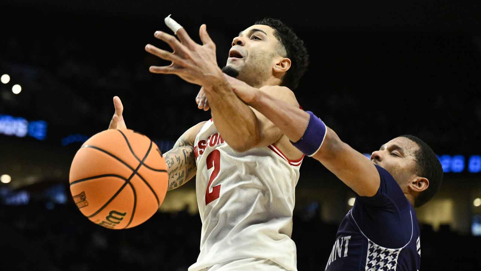 High Point Panthers guard Rob Martin (3) knocks the ball away from Wisconsin Badgers guard Nick Boyd (2) during the second half of a first round game of the men's 2026 NCAA Tournament at Moda Center.