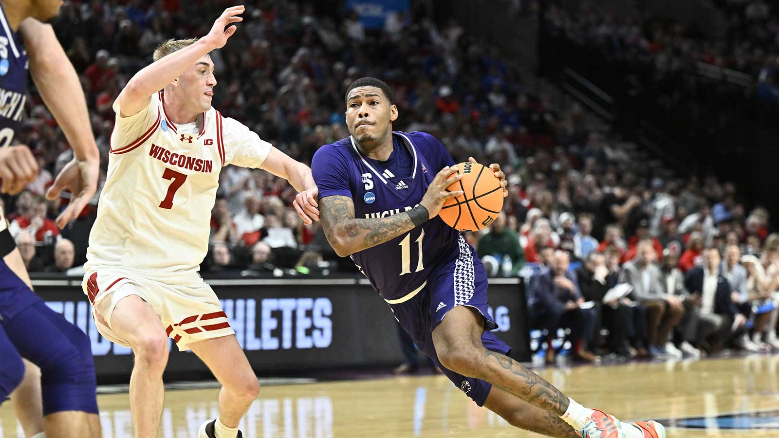 High Point Panthers forward Cam'ron Fletcher (11) drives to the basket against Wisconsin Badgers guard Andrew Rohde (7) during the second half of a first round game of the men's 2026 NCAA Tournament at Moda Center. Mandatory Credit: Craig Strobeck-Imagn Images