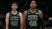 Boston Celtics center Luke Kornet (40) and center Al Horford (42) walk off the court during a time out during the second quarter against the Charlotte Hornets at Spectrum Center.