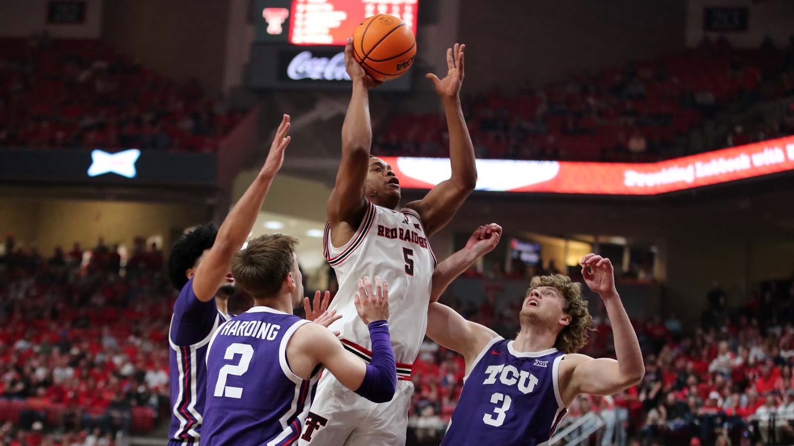 Texas Tech Red Raiders forward Josiah Moseley (5) drives against TCU Horned Frogs guard Liutauras Lelevicius (3) and guard Brock Harding (2) in the first half at United Supermarkets Arena.