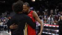 Houston Rockets forward Kevin Durant (7) hugs Washington Wizards forward Kyshawn George (L) on the court after their game at Capital One Arena. Mandatory Credit: Geoff Burke-Imagn Images