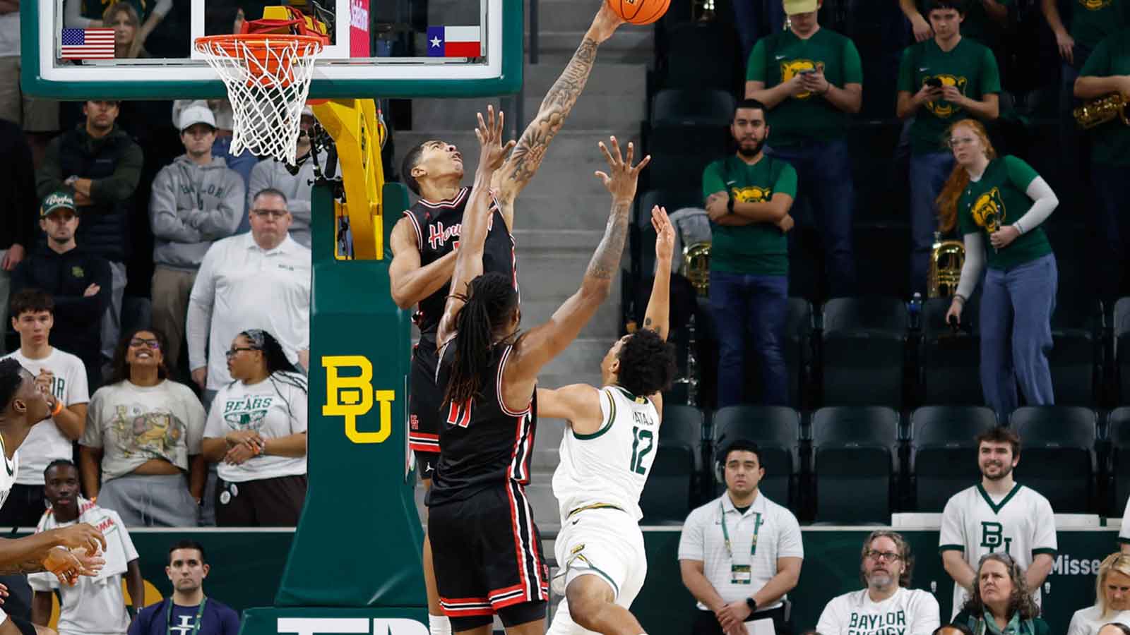 Arizona Wildcats guard Brayden Burries (5) drives to the hoop past Houston Cougars guard Kingston Flemings (4) during the first half during the men's Big 12 Conference Tournament Championship at T-Mobile Center. 